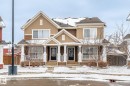 The property features a two-story design with a brown and tan exterior, accented by white trim - 4783 Crabapplle Run, Edmonton, AB  - Outdoor With Facade 