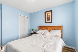 This room features light blue walls, a white ceiling, and hardwood flooring - 