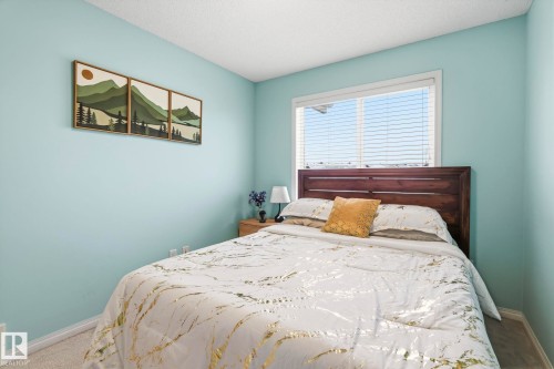 This room features light blue walls, a window with blinds, and carpeted flooring - 4783 Crabapplle Run, Edmonton, AB - Indoor Photo Showing Bedroom