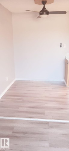 This room features wood-look flooring and a ceiling fan - 307 6307 118 Ave, Edmonton, AB - Indoor
