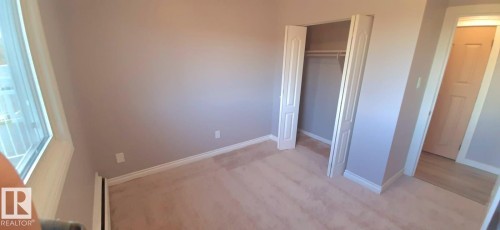 This room features light-colored carpeting, neutral painted walls, and white trim - 307 6307 118 Ave, Edmonton, AB - Indoor Photo Showing Other Room
