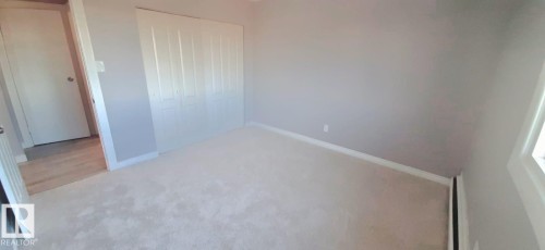 This room features light-colored carpeting, light gray walls, and white trim - 307 6307 118 Ave, Edmonton, AB - Indoor Photo Showing Other Room