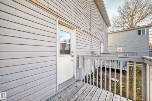 The property features durable siding and a wooden deck - 6 1580 Millwoods Road E, Edmonton, AB - Outdoor With Deck Patio Veranda With Exterior