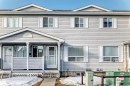 The property features light gray horizontal siding and white window trim - 6 1580 Millwoods Road E, Edmonton, AB  - Outdoor With Facade 