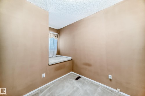 This room features a window with blinds and curtains, a carpeted floor, and neutral-toned walls - 6 1580 Millwoods Road E, Edmonton, AB - Indoor Photo Showing Other Room