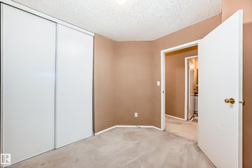 This room features light brown walls, carpeted flooring, and a white ceiling - 6 1580 Millwoods Road E, Edmonton, AB - Indoor Photo Showing Other Room