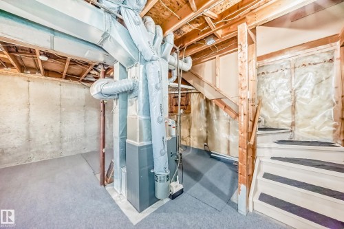 The property features an unfinished basement with exposed wooden beams and concrete walls, providing an opportunity for customization - 6 1580 Millwoods Road E, Edmonton, AB - Indoor Photo Showing Basement