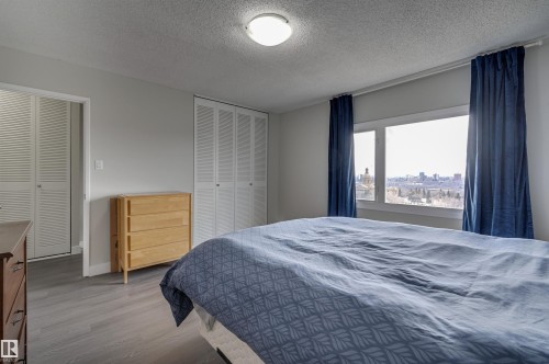 Bedroom featuring a view of the city, light gray walls, and gray flooring - 1202 9909 110 Street Nw, Edmonton, AB - Indoor Photo Showing Bedroom