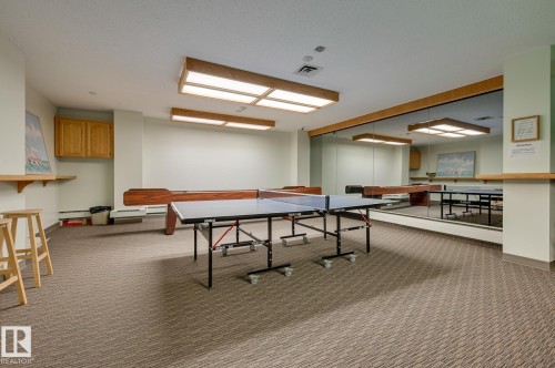 Recreation room featuring carpeted flooring, overhead lighting, and a mirrored wall - 1202 9909 110 Street Nw, Edmonton, AB - Indoor Photo Showing Other Room
