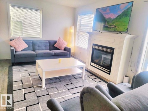 33 249 Edwards Drive, Edmonton, AB - Indoor Photo Showing Living Room With Fireplace