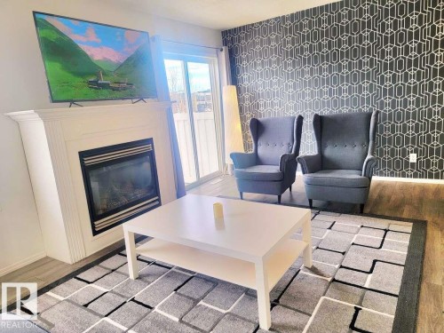 33 249 Edwards Drive, Edmonton, AB - Indoor Photo Showing Living Room With Fireplace