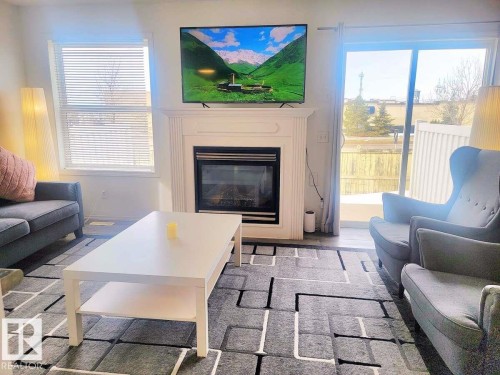 33 249 Edwards Drive, Edmonton, AB - Indoor Photo Showing Living Room With Fireplace