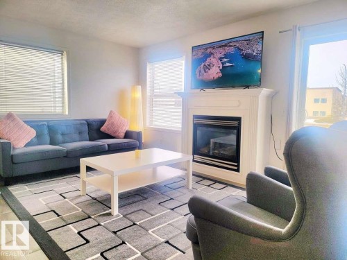 33 249 Edwards Drive, Edmonton, AB - Indoor Photo Showing Living Room With Fireplace