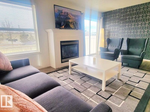 33 249 Edwards Drive, Edmonton, AB - Indoor Photo Showing Living Room With Fireplace