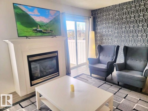 33 249 Edwards Drive, Edmonton, AB - Indoor Photo Showing Living Room With Fireplace