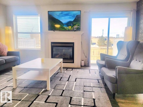 33 249 Edwards Drive, Edmonton, AB - Indoor Photo Showing Living Room With Fireplace