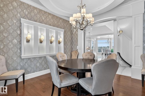 Formal dining area featuring hardwood floors and an ornate chandelier - 1413 Woodward Crescent, Edmonton, AB - Indoor Photo Showing Dining Room