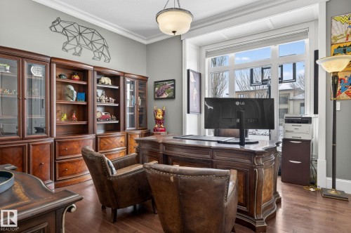 This property features an office space with hardwood floors and extensive built-in wooden cabinetry - 1413 Woodward Crescent, Edmonton, AB - Indoor