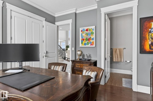 This room features hardwood flooring, elegant crown molding, and paneled doors - 1413 Woodward Crescent, Edmonton, AB - Indoor Photo Showing Dining Room