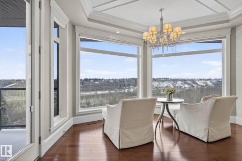 This room features extensive windows offering panoramic views of the surrounding landscape, complemented by elegant hardwood flooring - 1413 Woodward Crescent, Edmonton, AB - Indoor