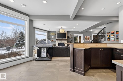 Spacious living area featuring large windows, recessed lighting, and tile flooring - 1413 Woodward Crescent, Edmonton, AB - Indoor