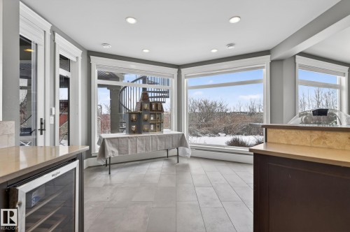 This versatile space features large windows that offer expansive views of the outdoors - 1413 Woodward Crescent, Edmonton, AB - Indoor