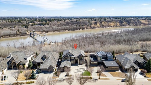 Two-story home with a multi-gabled roofline, featuring an attached garage and paved driveway - 1413 Woodward Crescent, Edmonton, AB - Outdoor