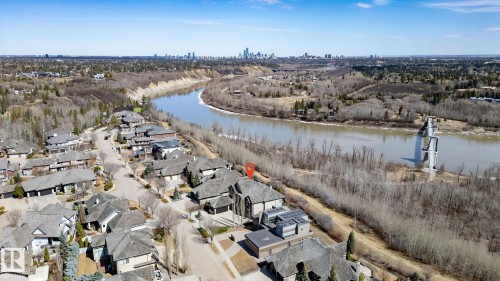 Aerial perspective of a property within a residential development, bordered by a river and natural landscape - 1413 Woodward Crescent, Edmonton, AB - Outdoor