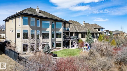 Multi-level stucco exterior with numerous large windows - 1413 Woodward Crescent, Edmonton, AB - Outdoor With View