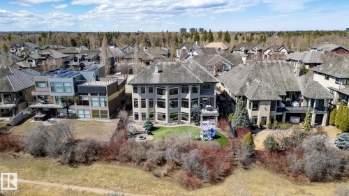 Multi-level residence featuring a terraced backyard with mature landscaping and a fire pit area - 1413 Woodward Crescent, Edmonton, AB - Outdoor With Facade