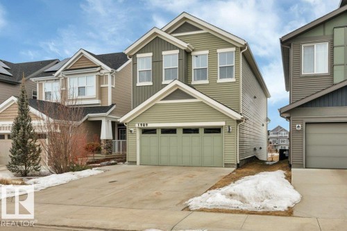 Craftsman-style house featuring concrete driveway, board and batten siding, and an attached garage - 1909 Davidson Wynd, Edmonton, AB - Outdoor With Facade
