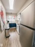 The kitchen features a stainless steel refrigerator, white upper cabinetry, blue lower cabinetry, and a white subway tile backsplash - 36 17409 95 Street, Edmonton, AB  - Indoor Photo Showing Kitchen 
