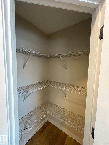 This pantry features wire shelving on three walls, providing storage potential, and a hardwood floor - 56 Salisbury Avenue, St. Albert, AB - Indoor With Storage