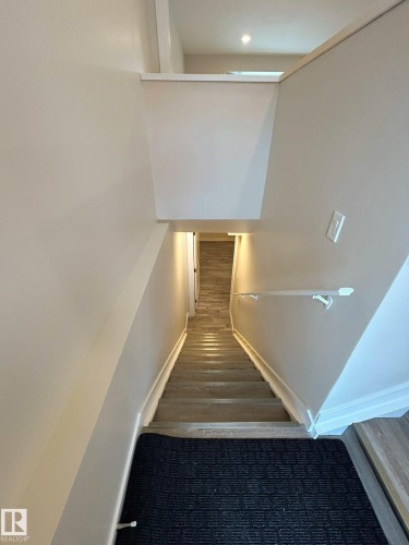 Staircase featuring wooden steps and a white handrail - 56 Salisbury Avenue, St. Albert, AB - Indoor Photo Showing Other Room