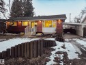 The property features red siding, a front porch with white railings, and a bay window - 56 Salisbury Avenue, St. Albert, AB  - Outdoor 