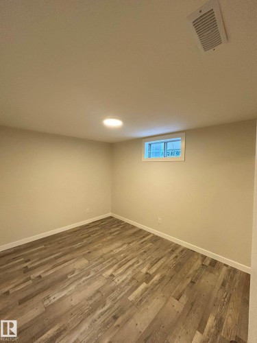 The property features durable flooring, a window, and recessed lighting - 56 Salisbury Avenue, St. Albert, AB - Indoor Photo Showing Other Room