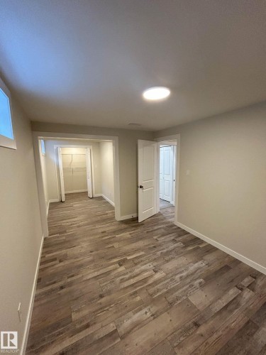 This room features wood-look flooring and light-colored walls - 56 Salisbury Avenue, St. Albert, AB - Indoor Photo Showing Other Room