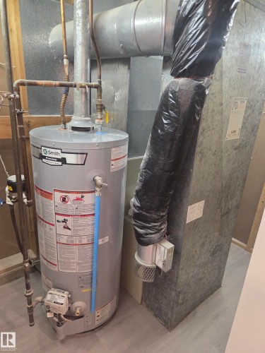 Water heater and associated utility piping - 56 Salisbury Avenue, St. Albert, AB - Indoor Photo Showing Basement