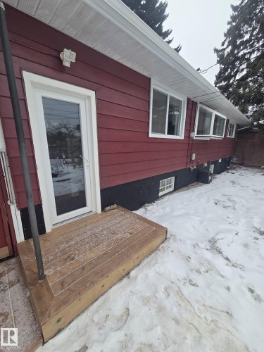 The property features red horizontal siding with white trim around windows and doors, and white soffits - 56 Salisbury Avenue, St. Albert, AB - Outdoor With Exterior