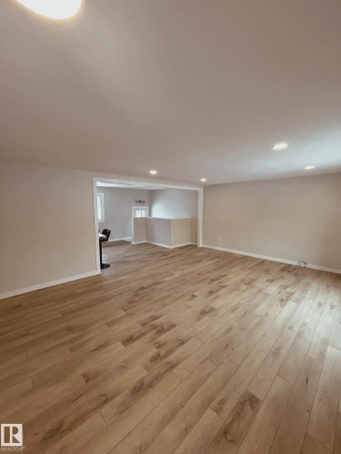 Spacious room featuring light wood-style flooring, light-colored walls, and recessed lighting - 56 Salisbury Avenue, St. Albert, AB - Indoor Photo Showing Other Room