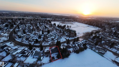 Aerial view of the property, highlighted in red, situated within a residential area with snow-covered grounds and surrounding trees - 56 Salisbury Avenue, St. Albert, AB - Outdoor With View