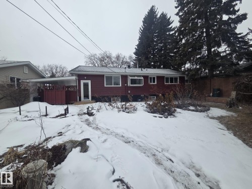 The property features a red exterior with white-framed windows and a covered patio area - 56 Salisbury Avenue, St. Albert, AB - Outdoor