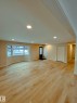 Spacious living area featuring light-toned flooring, ample recessed lighting, and a prominent bay window - 56 Salisbury Avenue, St. Albert, AB  - Indoor Photo Showing Other Room 