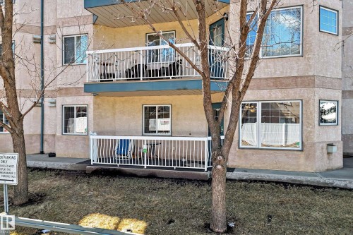 Exterior view of the property featuring a balcony with white railings and an outdoor patio area - 112 17150 94A Avenue, Edmonton, AB - Outdoor