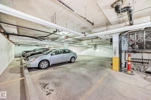 The property includes an underground parking area with concrete floors and overhead piping - 112 17150 94A Avenue, Edmonton, AB - Indoor Photo Showing Garage