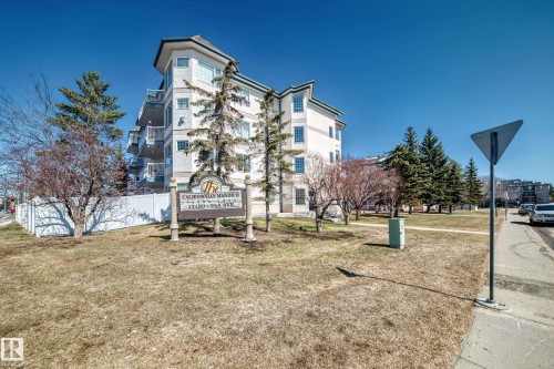 The property features a multi-story building with a light-colored exterior and bay windows - 112 17150 94A Avenue, Edmonton, AB - Outdoor