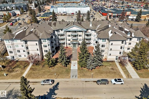 The property is a large multi-story building featuring a central entrance, multiple balconies, and a distinctive roofline with several turret-like structures - 112 17150 94A Avenue, Edmonton, AB - Outdoor