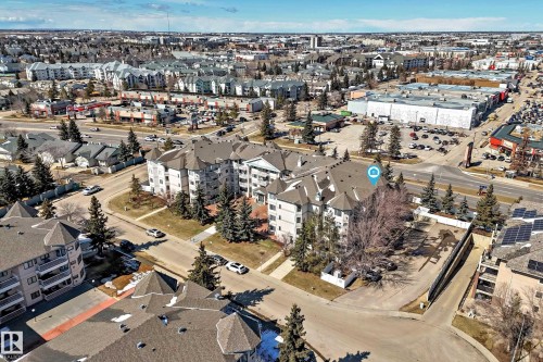 This property is located in a vibrant area, surrounded by various commercial establishments and residential buildings - 112 17150 94A Avenue, Edmonton, AB - Outdoor With View