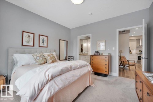 LARGE PRIMARY BEDROOM WITH WALK THROUGH 4 PC ENSUITE LEADING TO THE GENEROUS WALK IN CLOSET - 404 7463 May Common Nw, Edmonton, AB - Indoor Photo Showing Bedroom
