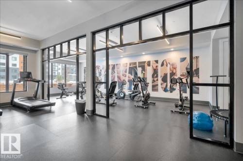 AMENITY ROOM - WELL EQUIPPED GYM WITH TREADMILLS, ROWING MACHINES, RECUMBANT BIKES, SPIN CYCLES, FREE WEIGHTS AND WEIGHT MACHINE - 404 7463 May Common Nw, Edmonton, AB - Indoor Photo Showing Gym Room